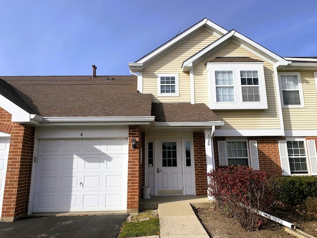308 Ashbury Ct Unit 1515-1, Roselle, IL 60172 - multi unit property featuring an attached garage, brick siding, driveway, and roof with shingles