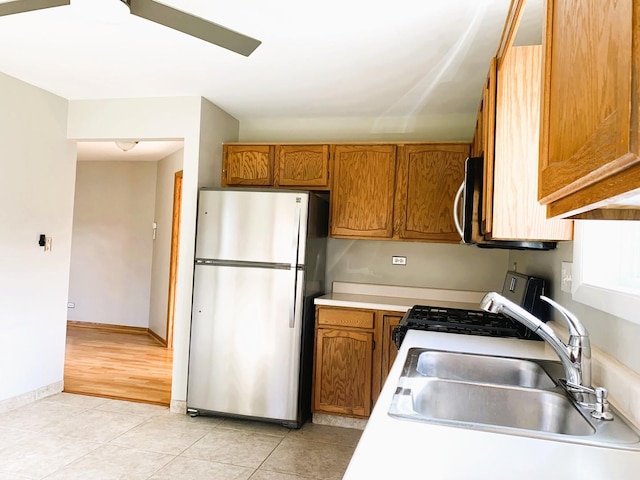 308 Ashbury Ct Unit 1515-1, Roselle, IL 60172 - kitchen featuring stainless steel appliances, brown cabinets, light countertops, and light tile patterned flooring