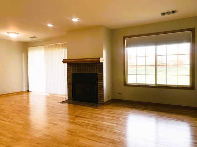 308 Ashbury Ct Unit 1515-1, Roselle, IL 60172 - unfurnished living room featuring light wood-type flooring, a brick fireplace, and recessed lighting