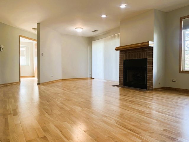 308 Ashbury Ct Unit 1515-1, Roselle, IL 60172 - unfurnished living room featuring light wood finished floors, a brick fireplace, and recessed lighting
