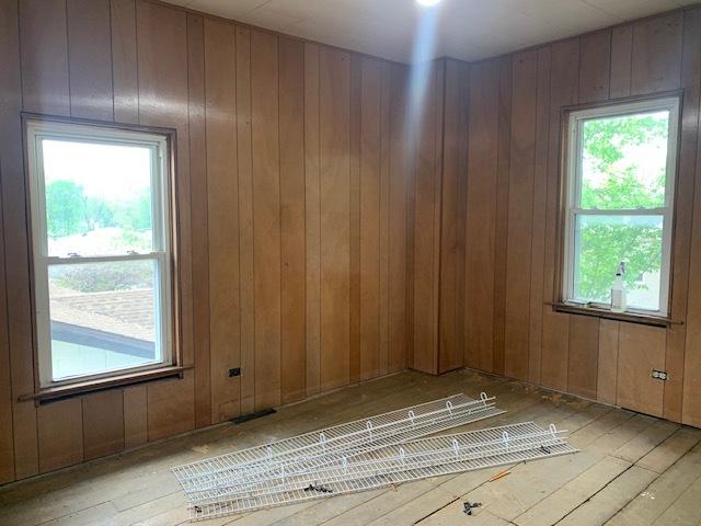 1013 Guion St, Ottawa, IL 61350 - unfurnished room with healthy amount of natural light, wood-type flooring, and wood walls