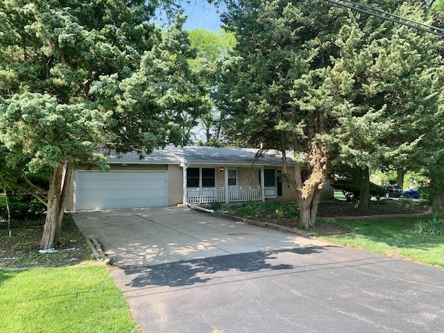132 Pratt Blvd, Roselle, IL 60172 - view of front facade featuring brick siding, an attached garage, concrete driveway, and covered porch