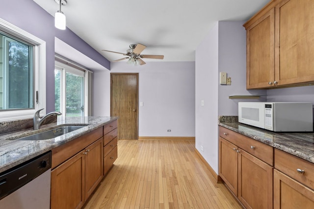 132 Pratt Blvd, Roselle, IL 60172 - kitchen with white microwave, dishwasher, a sink, brown cabinets, and light wood-style flooring