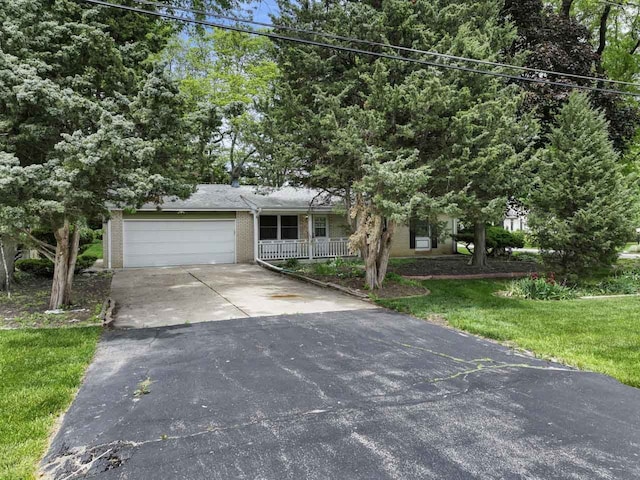 132 Pratt Blvd, Roselle, IL 60172 - view of front facade with driveway, an attached garage, brick siding, a front yard, and a porch