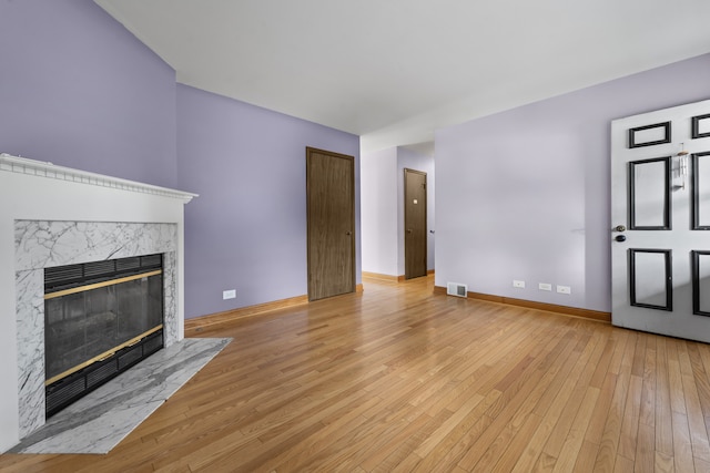 132 Pratt Blvd, Roselle, IL 60172 - unfurnished living room featuring light wood-style floors, a premium fireplace, and baseboards