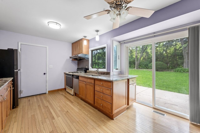 132 Pratt Blvd, Roselle, IL 60172 - kitchen with white range oven, freestanding refrigerator, a sink, brown cabinetry, and light wood-style floors