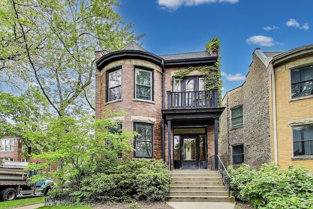 5357 N Wayne Ave, Chicago, IL 60640 - view of front of house with a balcony and brick siding
