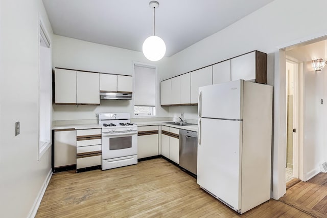 5357 N Wayne Ave, Chicago, IL 60640 - kitchen with white appliances, under cabinet range hood, light countertops, light wood-style flooring, and hanging light fixtures