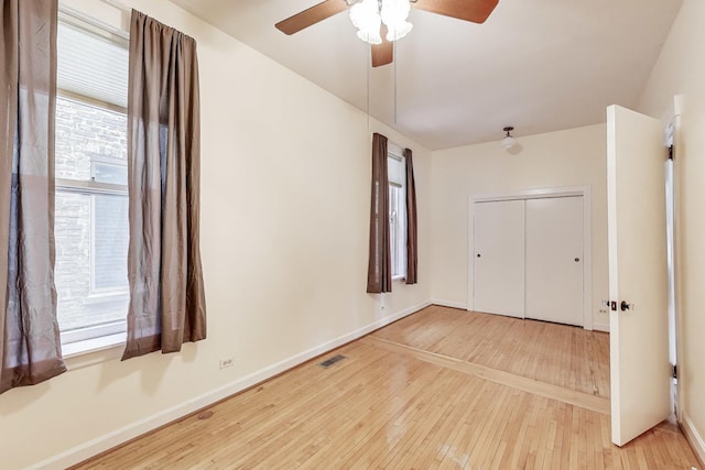 5357 N Wayne Ave, Chicago, IL 60640 - unfurnished bedroom with hardwood / wood-style flooring, baseboards, a closet, and a ceiling fan