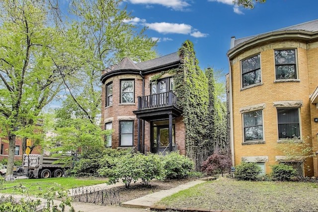 5357 N Wayne Ave, Chicago, IL 60640 - view of front facade with a balcony and brick siding