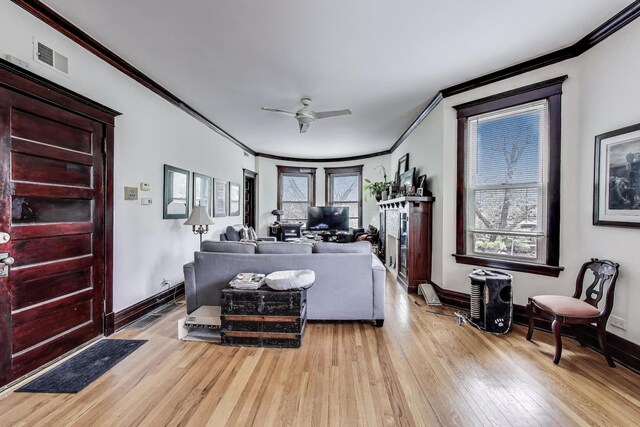 5357 N Wayne Ave, Chicago, IL 60640 - living room with ornamental molding, light wood-style flooring, ceiling fan, and baseboards