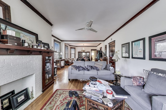 5357 N Wayne Ave, Chicago, IL 60640 - living room featuring ornamental molding, a fireplace, a ceiling fan, and wood finished floors