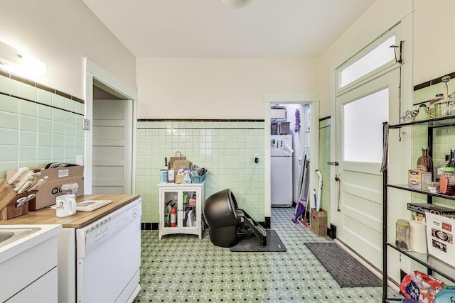 5357 N Wayne Ave, Chicago, IL 60640 - kitchen featuring tile walls, washer / dryer, dishwasher, white cabinets, and light floors