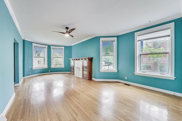 5357 N Wayne Ave, Chicago, IL 60640 - unfurnished living room with crown molding, healthy amount of natural light, a ceiling fan, and hardwood / wood-style flooring