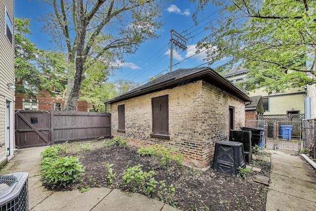 5357 N Wayne Ave, Chicago, IL 60640 - view of property exterior featuring a gate, brick siding, and central AC unit