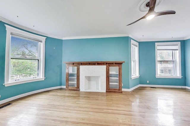 5357 N Wayne Ave, Chicago, IL 60640 - unfurnished living room featuring a ceiling fan, wood finished floors, ornamental molding, and baseboards