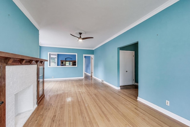 5357 N Wayne Ave, Chicago, IL 60640 - unfurnished living room with crown molding, a ceiling fan, hardwood / wood-style floors, a brick fireplace, and baseboards