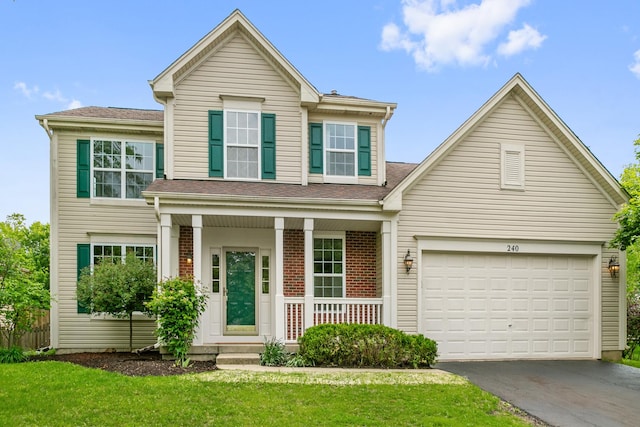 240 Regency Blvd, Sugar Grove, IL 60554 - traditional home featuring a porch, asphalt driveway, a garage, and a front yard