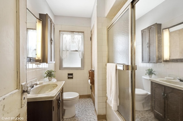 2630 N Austin Ave, Chicago, IL 60639 - bathroom featuring toilet, tile walls, vanity, and a shower with door