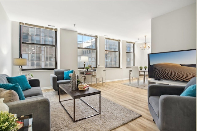 740 S Federal St Unit 804, Chicago, IL 60605 - living area featuring a chandelier, wood finished floors, and baseboards