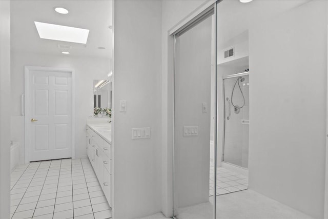 380 Green Bay Rd Unit 4D, Winnetka, IL 60093 - bathroom featuring tile patterned floors, a skylight, vanity, and an enclosed shower