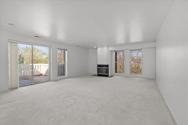 380 Green Bay Rd Unit 4D, Winnetka, IL 60093 - unfurnished living room with plenty of natural light, a fireplace with flush hearth, and light colored carpet