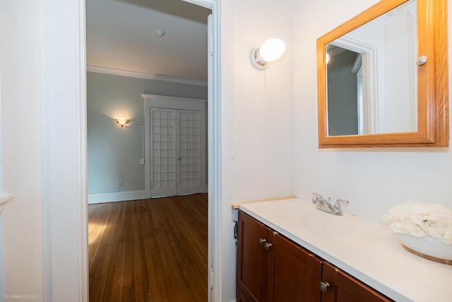 5707 S Blackstone Ave Unit 2, Chicago, IL 60637 - bathroom with vanity, wood finished floors, baseboards, and crown molding