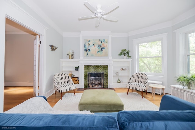 5707 S Blackstone Ave Unit 2, Chicago, IL 60637 - living room featuring a fireplace, a ceiling fan, wood finished floors, crown molding, and baseboards