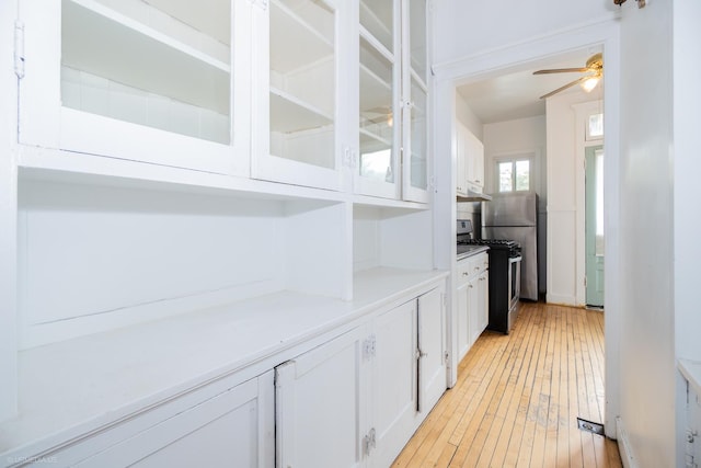 5707 S Blackstone Ave Unit 2, Chicago, IL 60637 - bar with stainless steel gas stove, ceiling fan, light wood finished floors, and under cabinet range hood