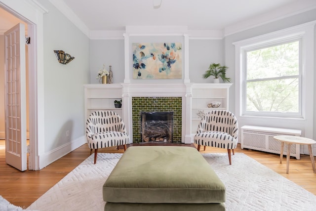 5707 S Blackstone Ave Unit 2, Chicago, IL 60637 - sitting room with radiator heating unit, wood finished floors, baseboards, and a tiled fireplace