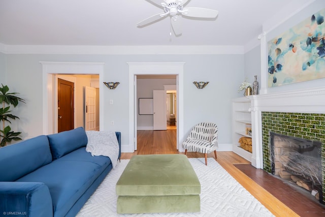 5707 S Blackstone Ave Unit 2, Chicago, IL 60637 - living area featuring wood finished floors, a tiled fireplace, baseboards, and ceiling fan