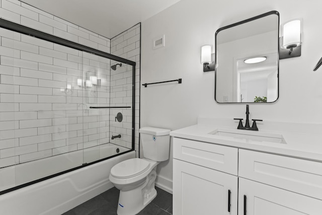 141 N La Grange Rd Unit 303, La Grange, IL 60525 - full bathroom with vanity, toilet, tile patterned floors, bath / shower combo with glass door, and baseboards