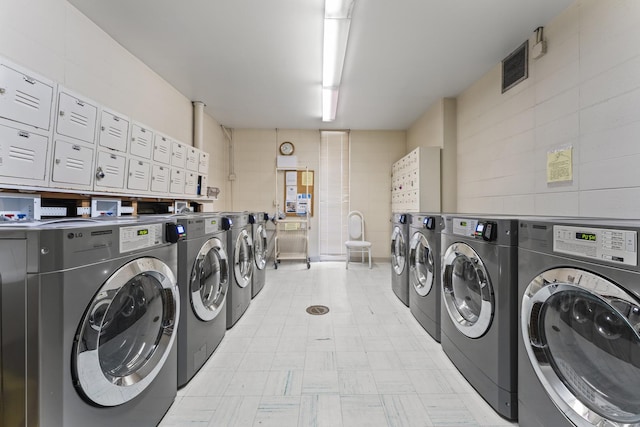 141 N La Grange Rd Unit 303, La Grange, IL 60525 - shared laundry featuring independent washer and dryer, tile walls, and light flooring