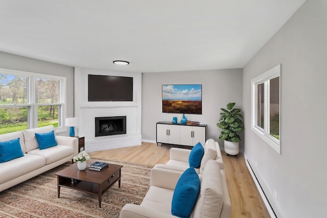 505 Barbara Ct, University Park, IL 60484 - living area featuring wood finished floors, a fireplace, and baseboard heating