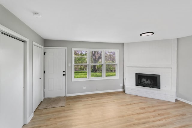 505 Barbara Ct, University Park, IL 60484 - unfurnished living room with light wood-type flooring, a fireplace, and baseboards