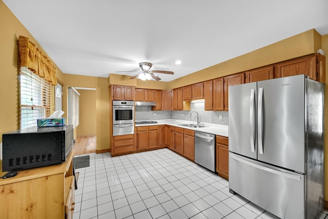301 N Illinois Ave, Glenwood, IL 60425 - kitchen with appliances with stainless steel finishes, a warming drawer, a sink, light countertops, and ceiling fan