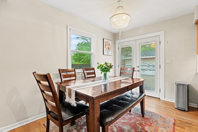 925 S Chestnut Ave, Arlington Heights, IL 60005 - dining space featuring french doors, a chandelier, baseboards, and light wood-style floors