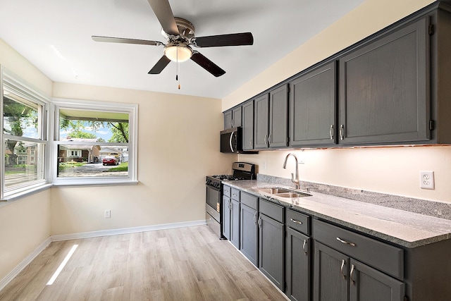 12237 S Avers Ave, Alsip, IL 60803 - kitchen with stainless steel appliances, a sink, light wood-type flooring, a ceiling fan, and baseboards