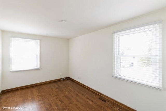 679 Aspen Dr, Buffalo Grove, IL 60089 - spare room with plenty of natural light and dark wood finished floors