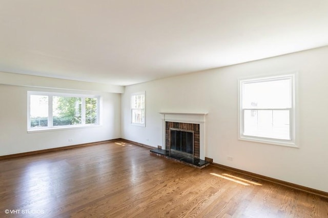 679 Aspen Dr, Buffalo Grove, IL 60089 - unfurnished living room featuring a brick fireplace and wood finished floors