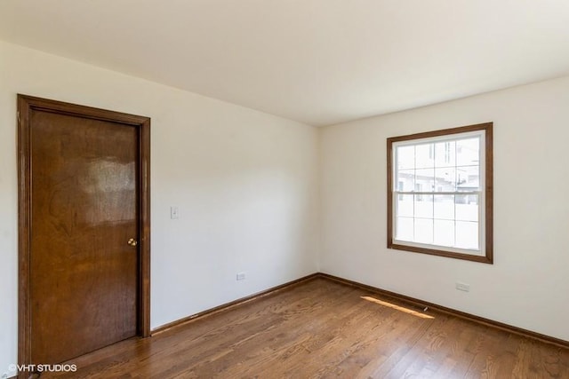 679 Aspen Dr, Buffalo Grove, IL 60089 - spare room with wood finished floors and baseboards