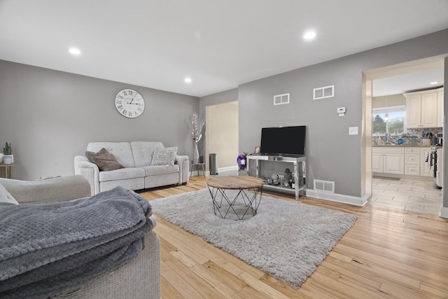 3805 Brighton Ct, Zion, IL 60099 - living room with light wood-type flooring, recessed lighting, and baseboards