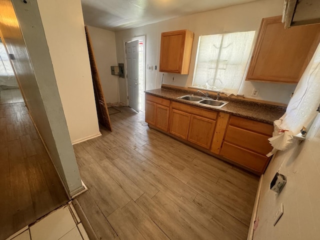 14508 Des Plaines St, Harvey, IL 60426 - kitchen with a sink, light wood-style flooring, and dark countertops