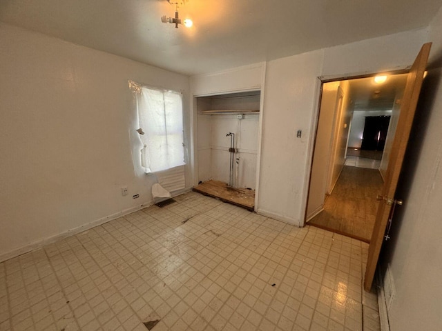 14508 Des Plaines St, Harvey, IL 60426 - unfurnished bedroom featuring baseboards, a closet, and light floors