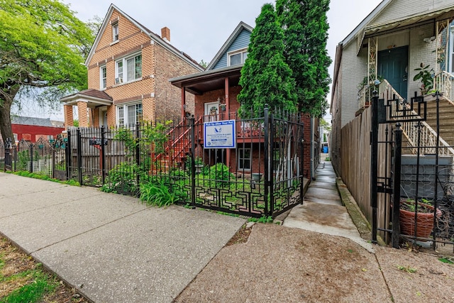 2807 S Spaulding Ave, Chicago, IL 60623 - view of front facade with brick siding, a gate, and a fenced front yard