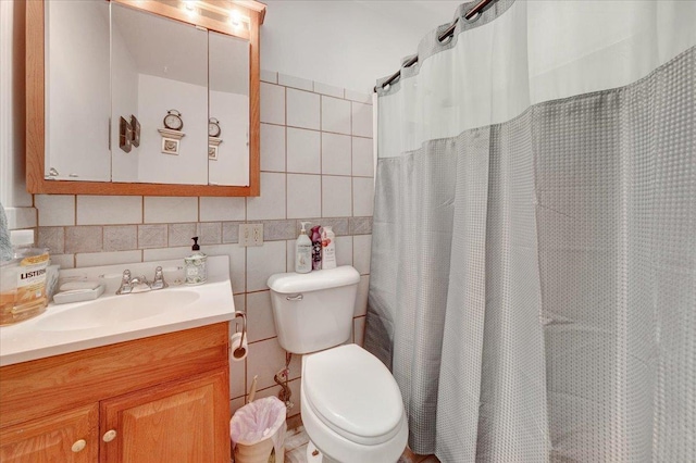 2511 Sangamon Dr, Champaign, IL 61821 - bathroom with tile walls, vanity, and a shower with curtain