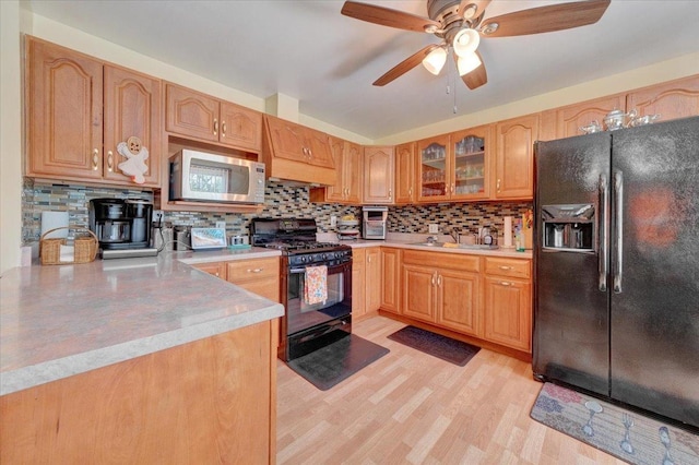 2511 Sangamon Dr, Champaign, IL 61821 - kitchen with black appliances, decorative backsplash, ceiling fan, light wood-style flooring, and light countertops