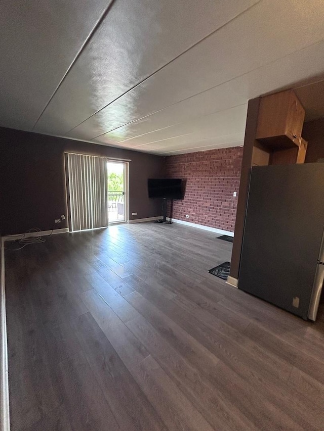 3012 171st St Unit D2, Hazel Crest, IL 60429 - unfurnished living room with wood finished floors, baseboards, brick wall, and a brick fireplace