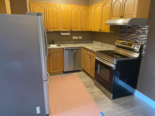 3012 171st St Unit D2, Hazel Crest, IL 60429 - kitchen featuring appliances with stainless steel finishes, under cabinet range hood, light wood-style flooring, a sink, and light brown cabinetry