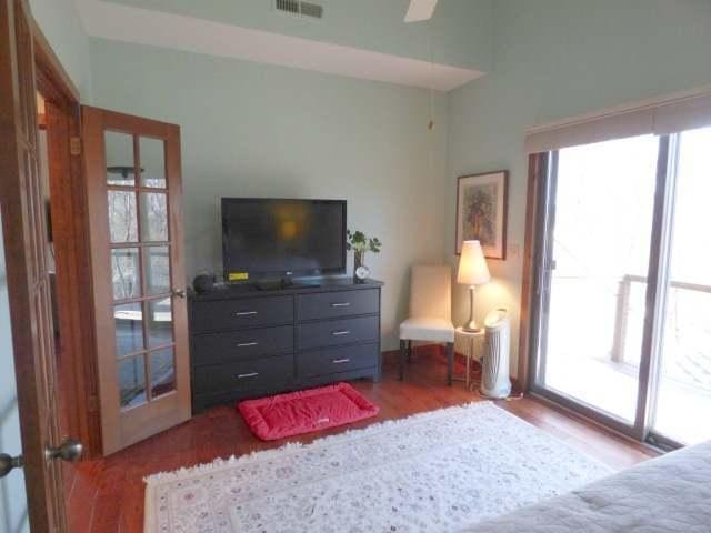 2 Tamarack Row, Galena, IL 61036 - bedroom with multiple windows, wood finished floors, and ceiling fan